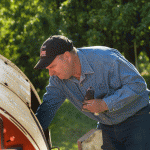 Jon Laraway wears denim and workd on his tractor